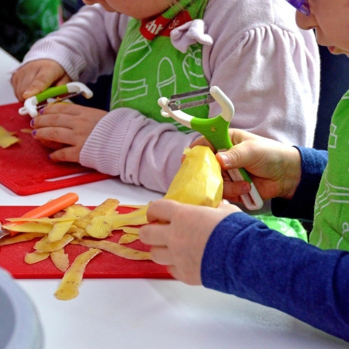children peeling potatoes